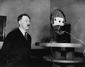 Adolf Hitler standing in front of a radio microphone